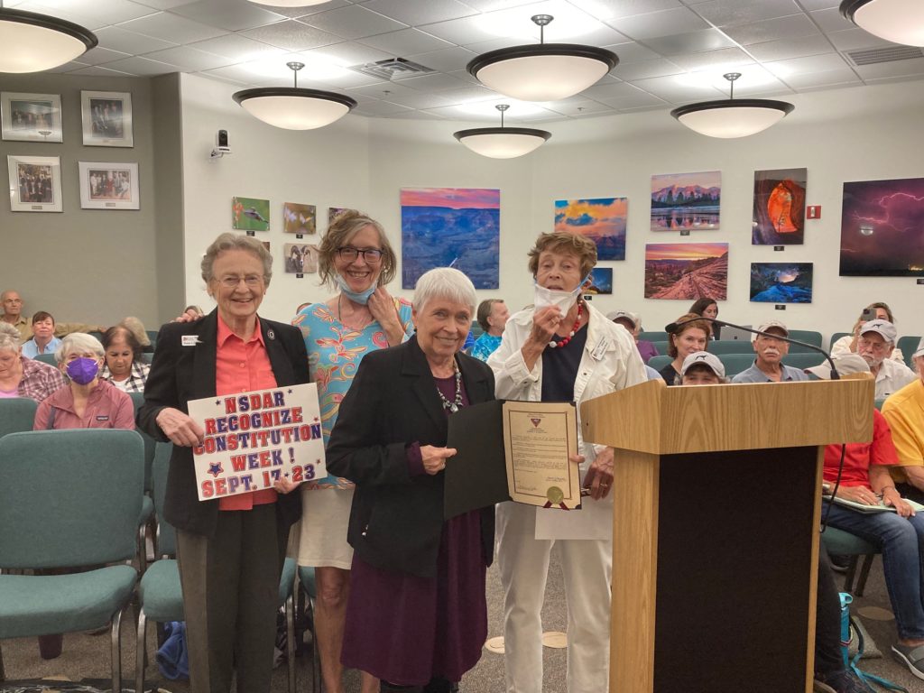 This photo shows four members of the Oak Creek Chapter, NSDAR, at a meeting of the City of Sedona and posing with a copy of a Constitution Week Proclamation.